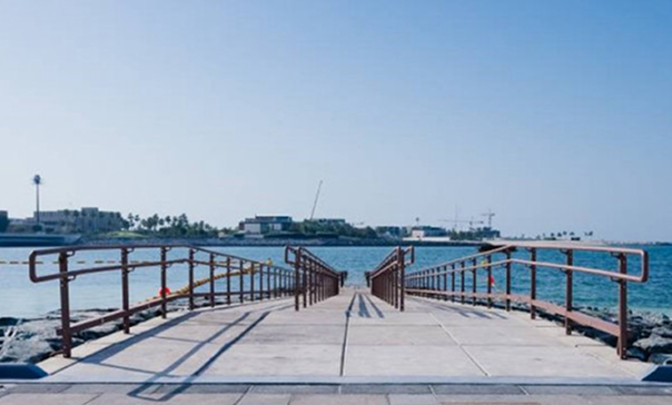 Accessible pier with handrails leading out to the sea